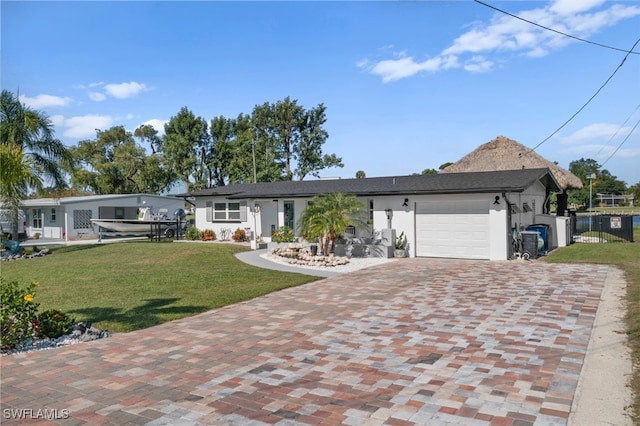 ranch-style home featuring stucco siding, a front lawn, decorative driveway, fence, and an attached garage