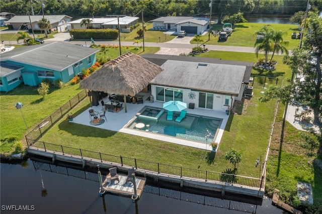 birds eye view of property with a water view and a residential view