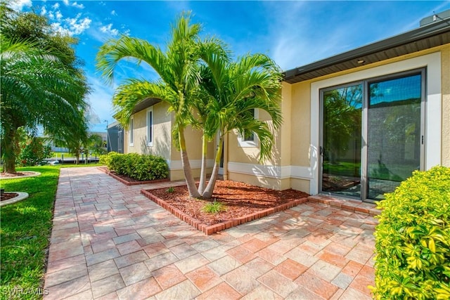 entrance to property with stucco siding