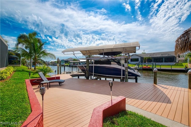 dock area with a yard, a water view, and boat lift