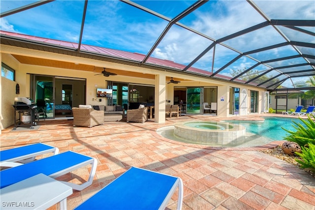 view of swimming pool featuring a patio, glass enclosure, ceiling fan, a pool with connected hot tub, and an outdoor living space