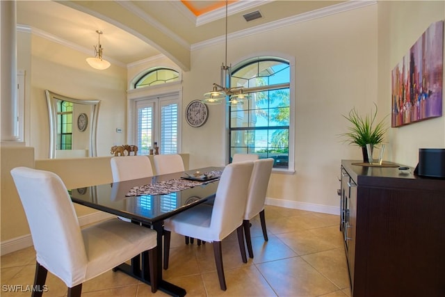 dining room featuring a chandelier, ornamental molding, visible vents, and baseboards