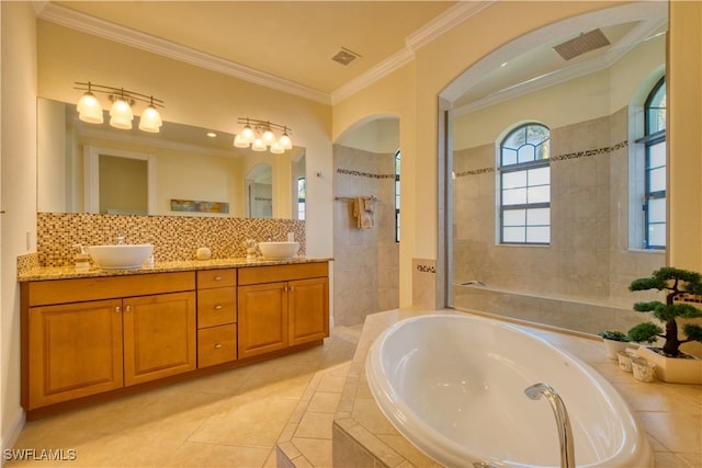 full bath with a garden tub, crown molding, visible vents, and a sink