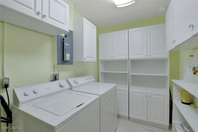 washroom featuring washer and clothes dryer, light tile patterned flooring, cabinet space, and electric panel