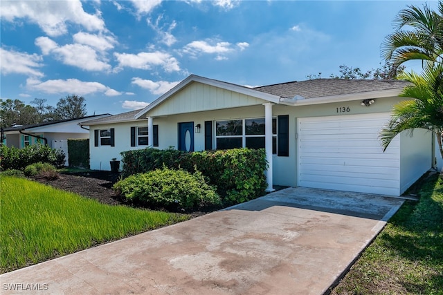 ranch-style home featuring a garage and driveway