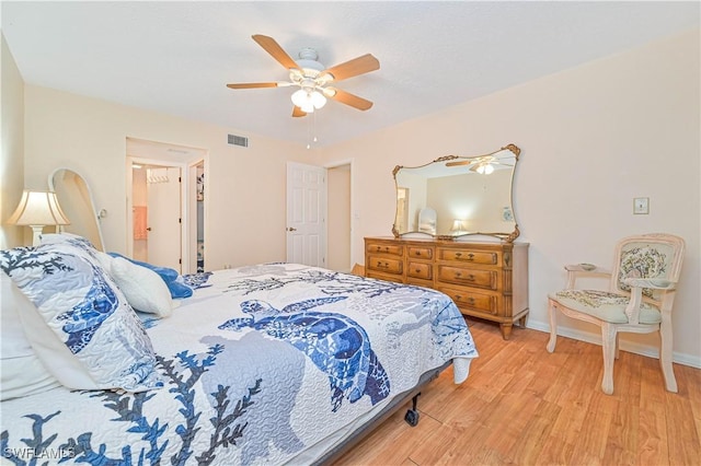 bedroom featuring light wood-style floors, visible vents, ceiling fan, and baseboards