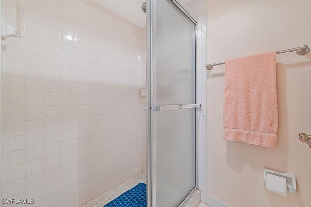 full bath featuring a shower stall