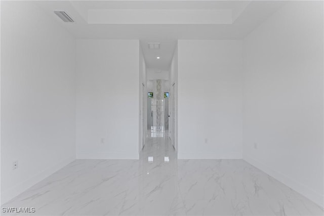 spare room featuring marble finish floor, visible vents, and baseboards