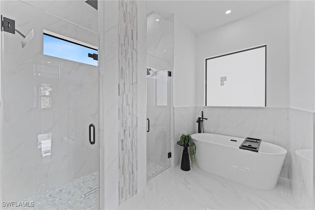 bathroom with marble finish floor, a soaking tub, a marble finish shower, and recessed lighting