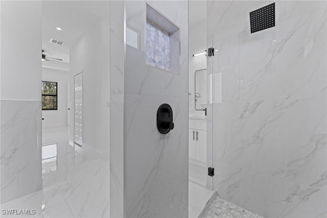 bathroom featuring marble finish floor, visible vents, and a marble finish shower