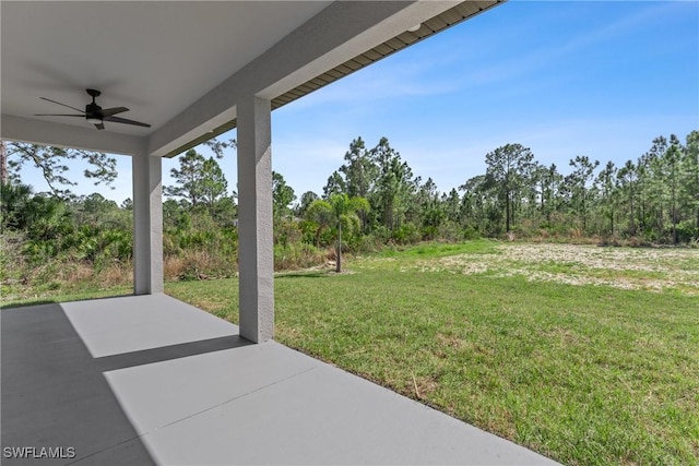 view of yard with ceiling fan and a patio