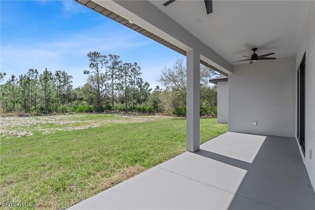 view of yard featuring a patio area and a ceiling fan