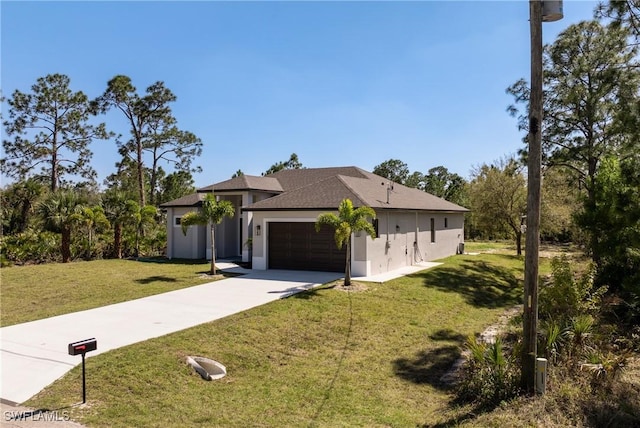 view of front of house with an attached garage, concrete driveway, a front yard, and stucco siding