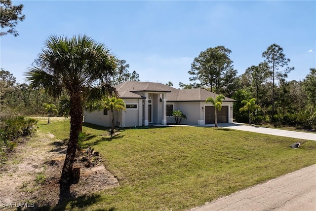 view of front of property with an attached garage, a front lawn, concrete driveway, and stucco siding