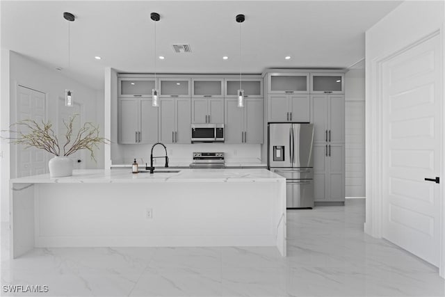 kitchen with marble finish floor, gray cabinets, visible vents, appliances with stainless steel finishes, and a sink