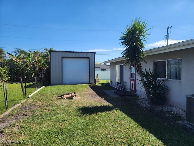 view of yard with fence and an outdoor structure