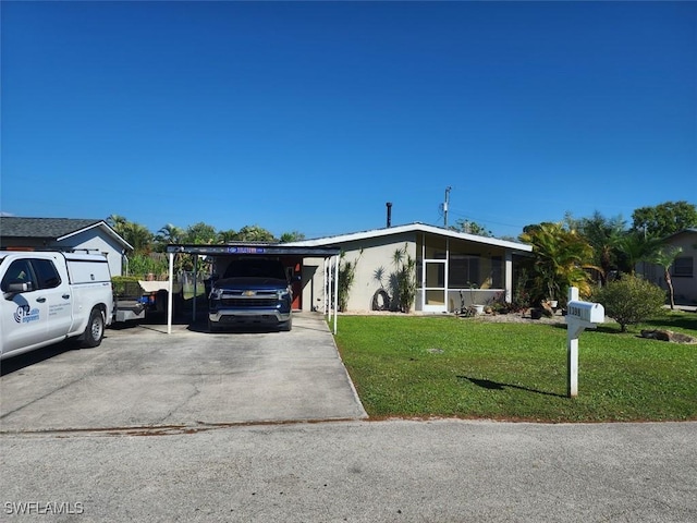 view of front of property with a carport, driveway, and a front lawn