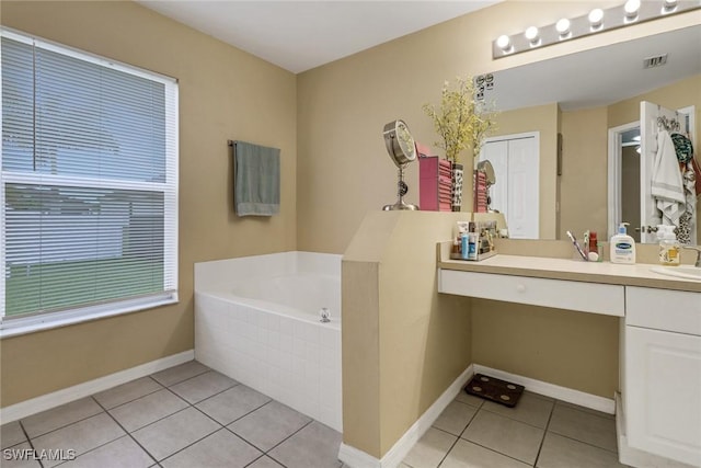 full bathroom featuring baseboards, visible vents, tile patterned floors, a garden tub, and vanity