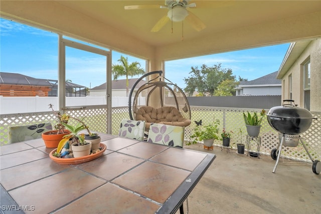 sunroom with a ceiling fan