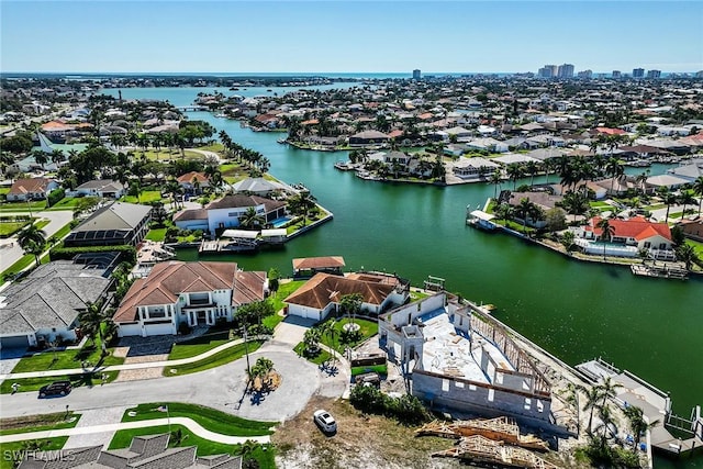 drone / aerial view with a water view and a residential view