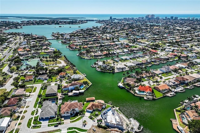 birds eye view of property with a water view and a residential view