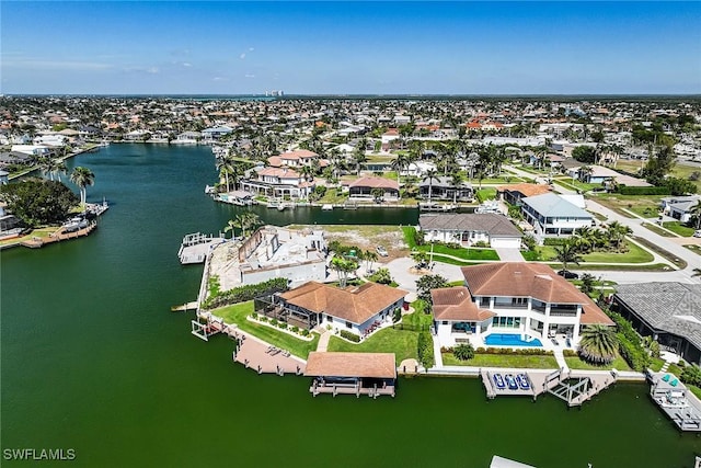 birds eye view of property featuring a water view and a residential view