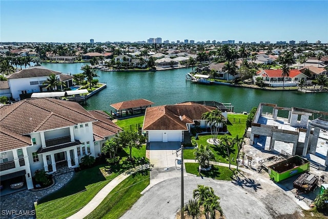 drone / aerial view featuring a water view and a residential view