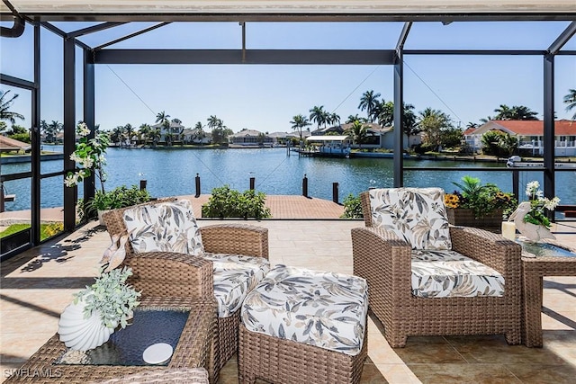 view of patio featuring a dock, a water view, and a lanai