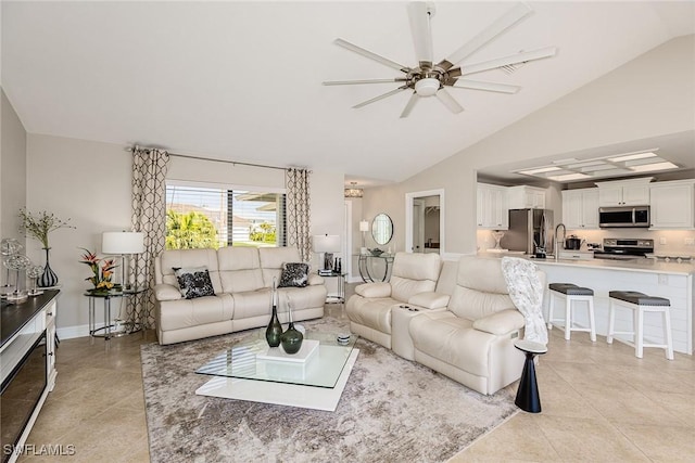 living room featuring light tile patterned floors, lofted ceiling, a ceiling fan, and baseboards