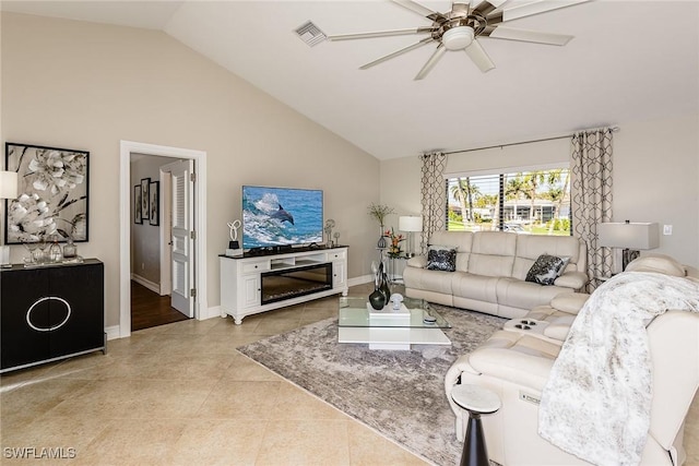 living area with lofted ceiling, ceiling fan, light tile patterned flooring, visible vents, and baseboards