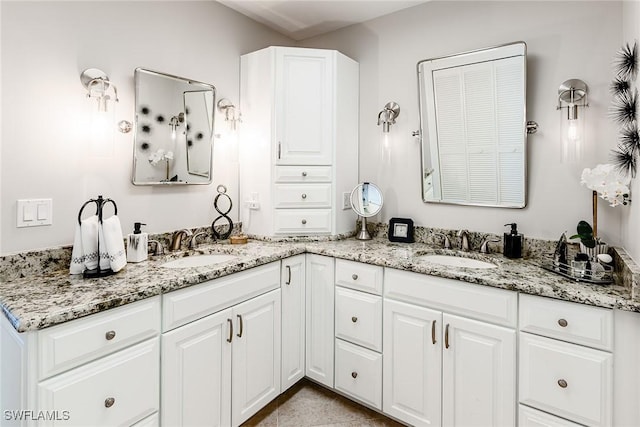 bathroom featuring double vanity and a sink