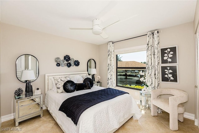 bedroom featuring tile patterned flooring, baseboards, and a ceiling fan