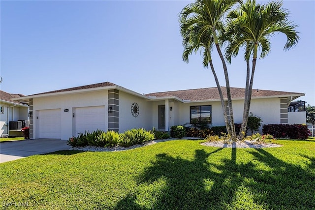 ranch-style house with driveway, a front yard, an attached garage, and stucco siding