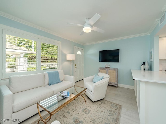 living area with visible vents, baseboards, ceiling fan, ornamental molding, and light wood-style floors