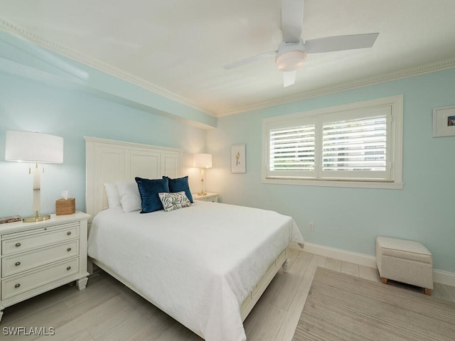 bedroom with a ceiling fan, crown molding, light wood-style flooring, and baseboards