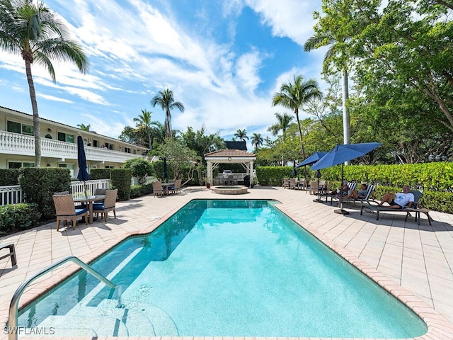 community pool featuring a gazebo, a patio, and fence