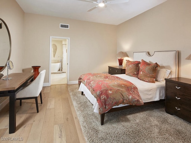 bedroom featuring light wood-type flooring, connected bathroom, visible vents, and baseboards