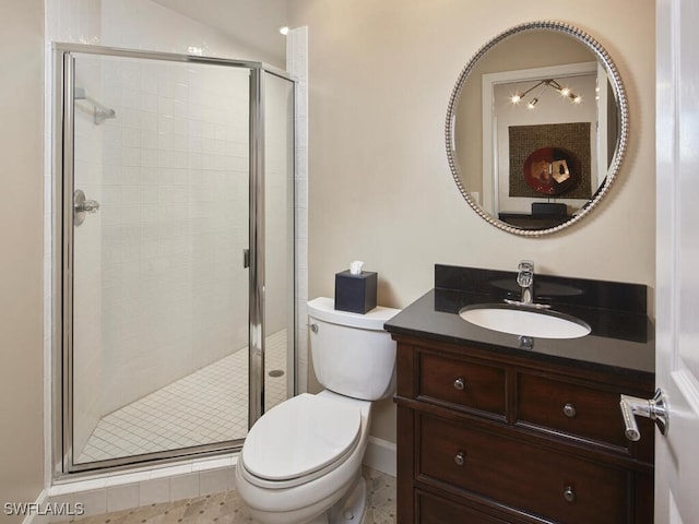 full bathroom featuring a stall shower, vanity, and toilet