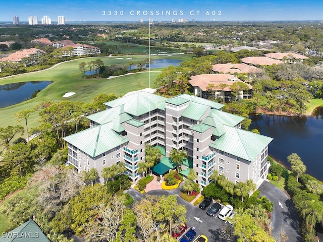 birds eye view of property featuring golf course view and a water view