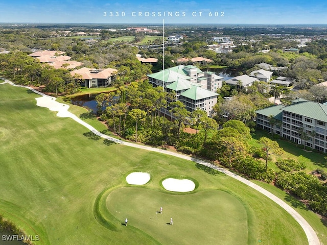 aerial view featuring golf course view and a water view