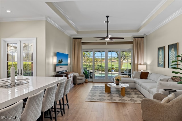 living area with ornamental molding, recessed lighting, light wood-style flooring, french doors, and a ceiling fan