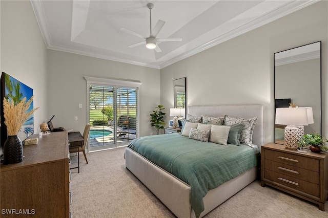 bedroom featuring access to exterior, light colored carpet, a raised ceiling, and ornamental molding