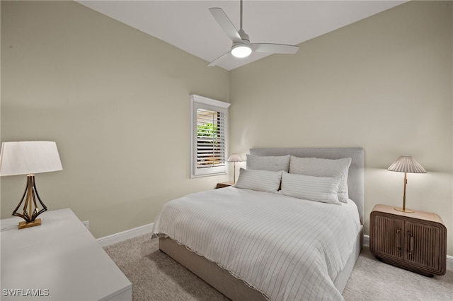 carpeted bedroom with baseboards, a ceiling fan, and vaulted ceiling