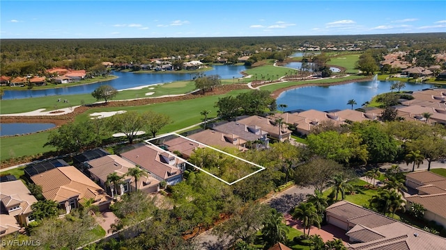 drone / aerial view with a residential view, a water view, and view of golf course