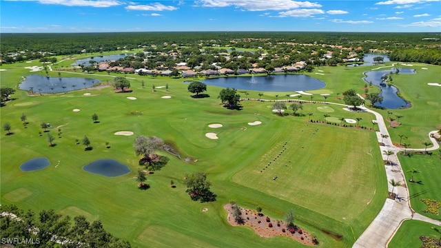 drone / aerial view featuring view of golf course and a water view