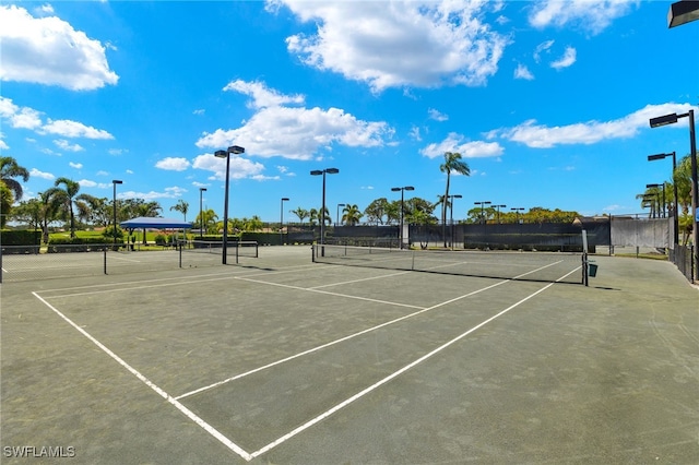 view of tennis court featuring fence