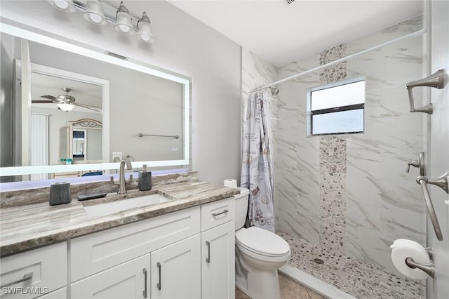 full bath with toilet, visible vents, vanity, a ceiling fan, and a marble finish shower