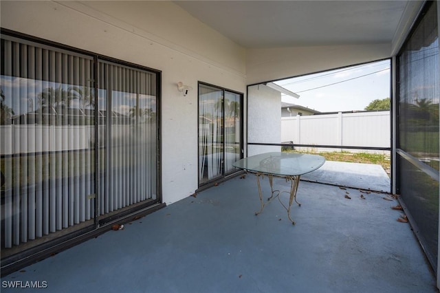 unfurnished sunroom featuring lofted ceiling