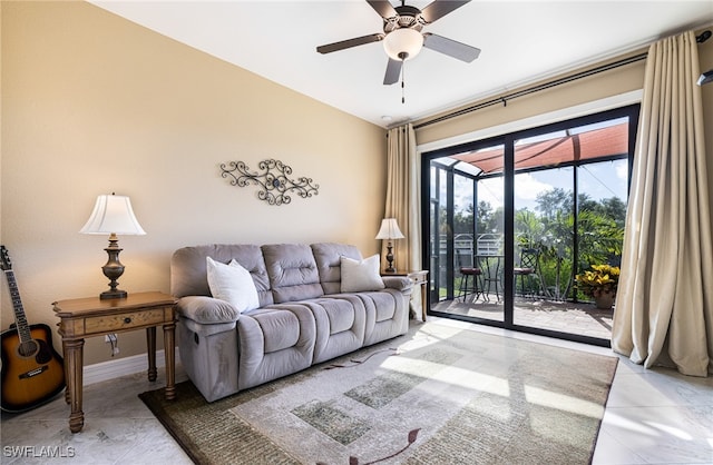 living room featuring ceiling fan, light tile patterned floors, a sunroom, and baseboards