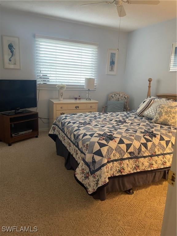 bedroom featuring a ceiling fan and carpet